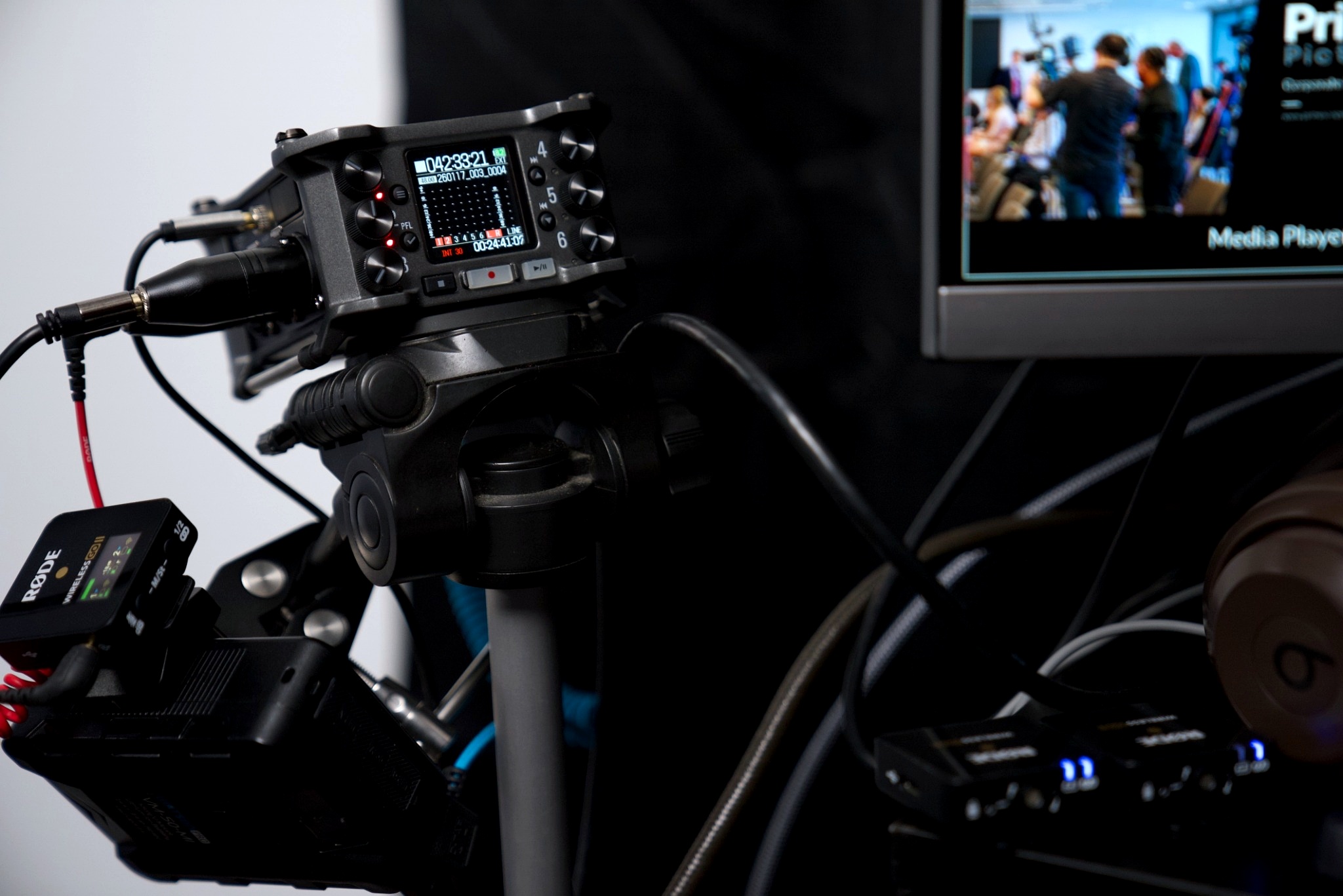 Professional camera setup with tripod, lens, lighting, and accessories arranged for a studio photoshoot or video recording.