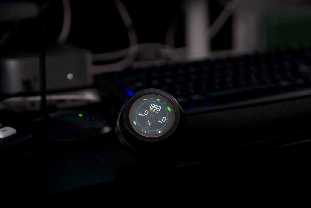 Millisecond timing machine set up in a dark environment with illuminated display and control buttons visible.