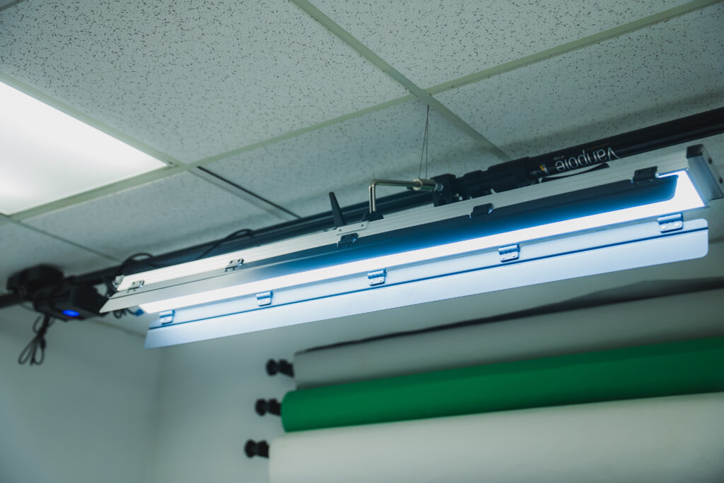 Studio ceiling lights with adjustable fixtures, providing bright, even illumination for photography or video shoots.